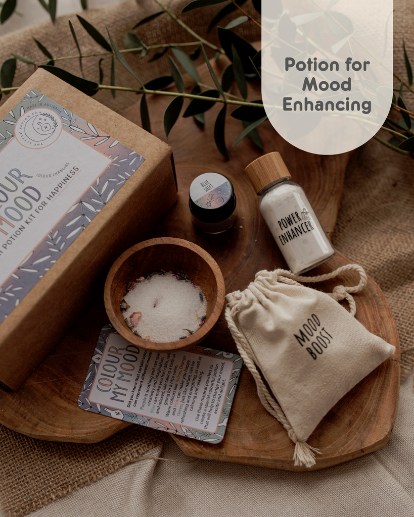 A colour changing potion kit with changing your mood. Image shows potion ingredients, mood boost in cotton bag, power enhancer in a bottle and a spell card.