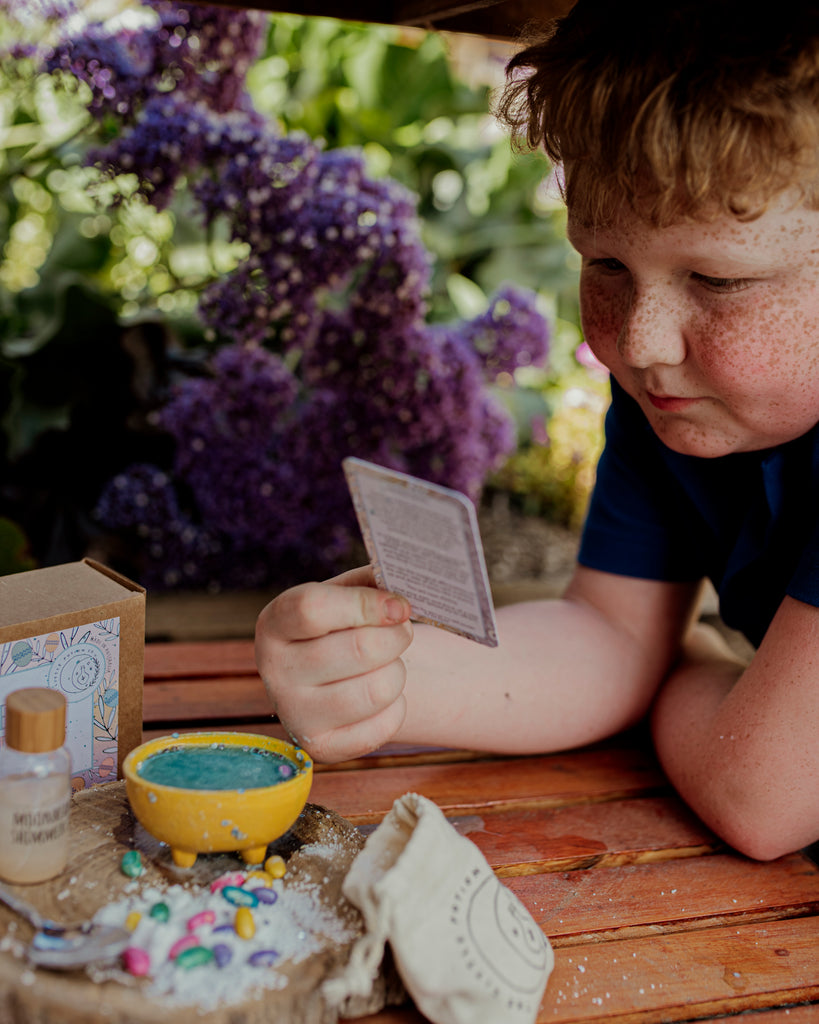 child reading the spell card about creating joy this easter