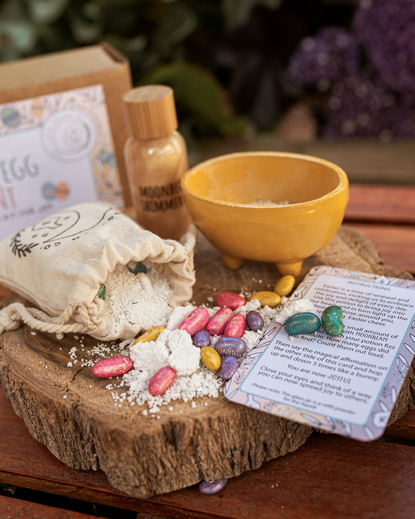 Easter egg potion kit for joy on a wooden board and a yellow little cauldron