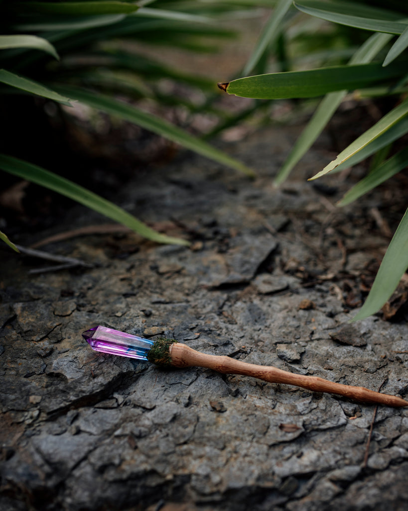 unicorn crystal resin wand with wooden handle and moss