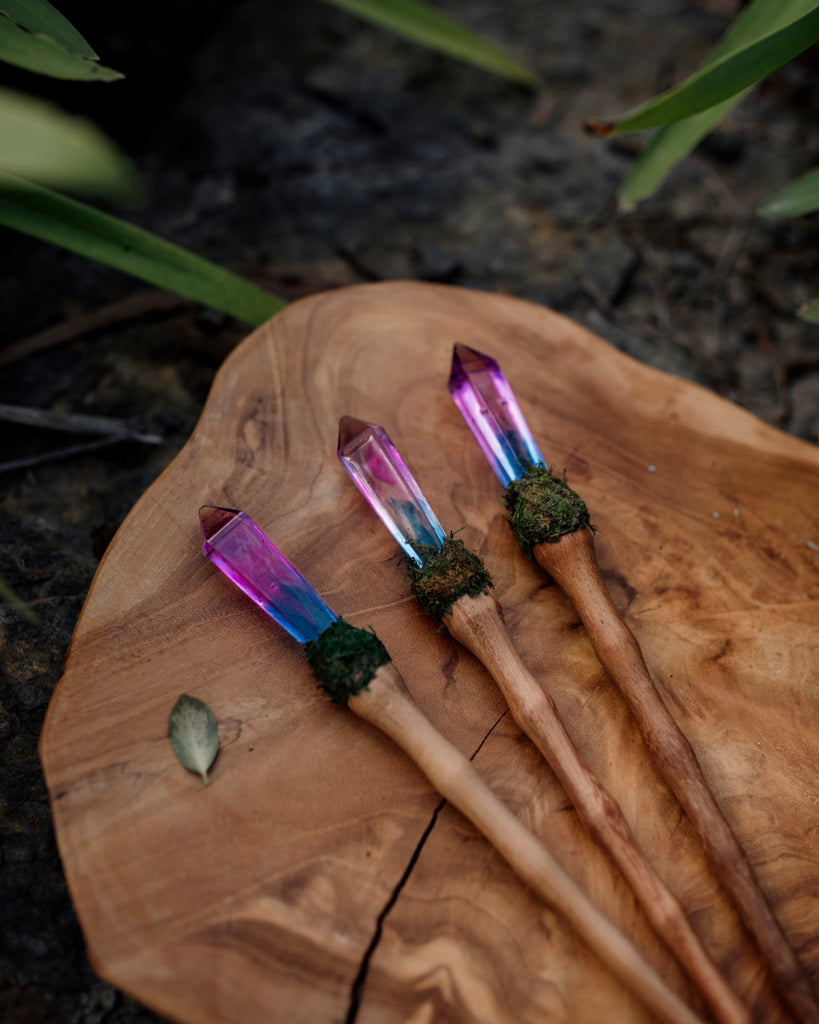 unicorn crystal resin wand with wooden handle and moss